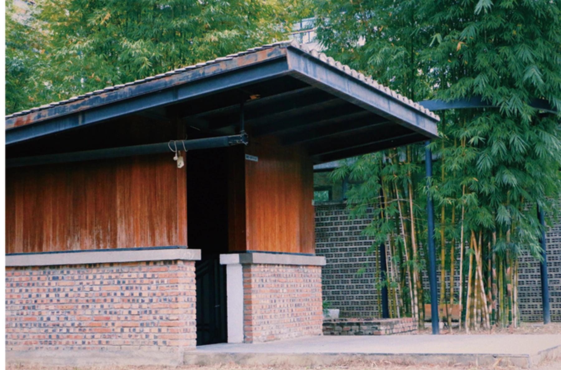 Brick pavilion beside bamboo